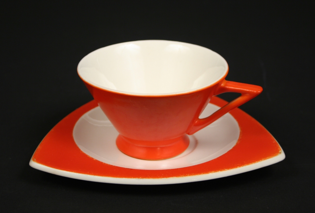 Salem China. Salem, OH (1898 - ), Vincent Bloomhall, Herbert Smith, Don Schreckengost, et al, designers), Mandarine Tricorne Art Deco orange cup and saucer, 1930s (patented), china, glazed, Gift of Margaret Carney and Bill Walker, 2019.174.