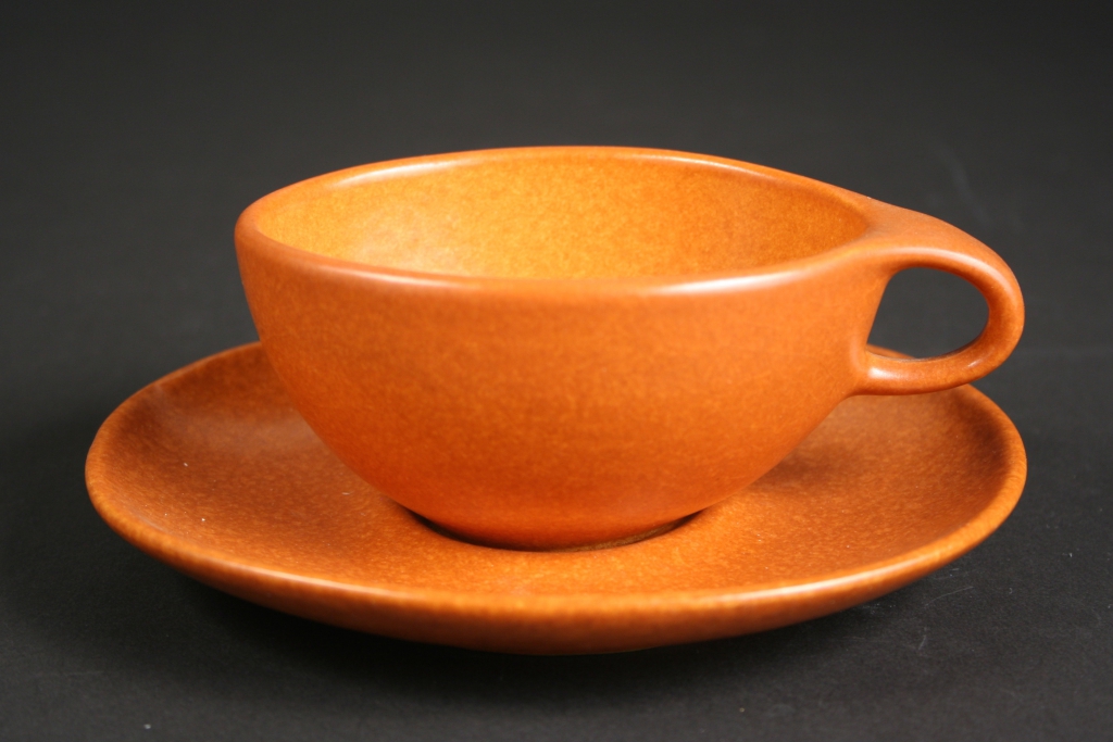 Raymor by Roseville, manufacturer, Roseville, Ohio (1890-1953), Ben Seibel, designer (1918-1985), terra cotta (pumpkin) Raymor Modern Stoneware cup and saucer, 1952-1954, stoneware, Ram-pressed, glazed, Museum Purchase, 2016.215