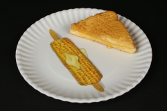Mary Lake-Thompson white melamine plate with grilled cheese and corn on the cob