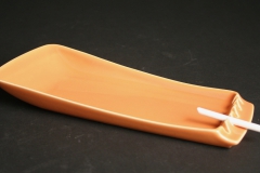 Hyalyn Porcelain cantaloupe-colored ashtray with candy cigarette